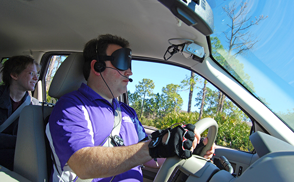 Mark Riccobono drives a car with a tactile interface in the Blind Driver Challenge.