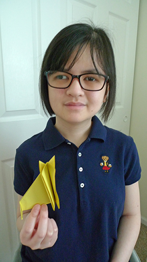 Andrea Cataquiz holds one of her origami creations.