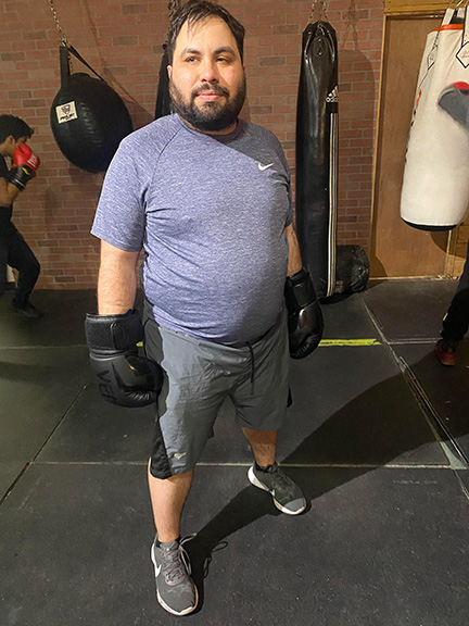 Dustin Cather wears his boxing gloves at the gym.