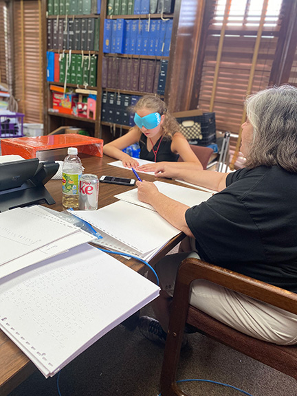 A child reads aloud to a BELL volunteer.