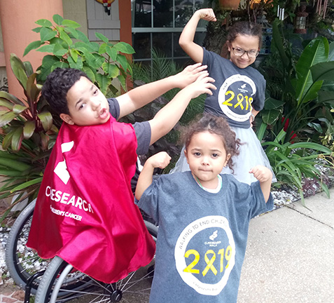 Manny and two of his friends dress as superheroes.