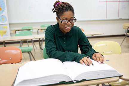 A teenage girl reads Braille during the contest.