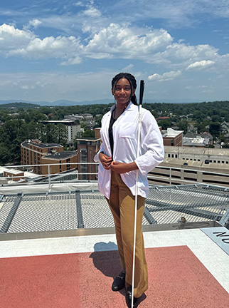 Aunya Anderson poses for a photo on a rooftop terrace. 