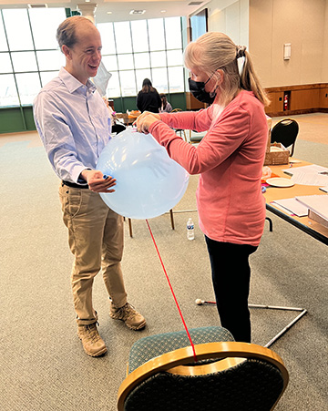 Justin Harford and Jenny Carmack conduct a balloon experiment at a training session for STEM2U coordinators.