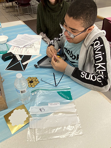 At a New Jersey NFB STEM2U program a boy constructs a Webb telescope.