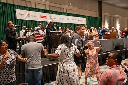 Conventioneers dance in the aisles during live entertainment at the opening ceremonies.