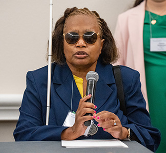Denise Avant speaks at a microphone.