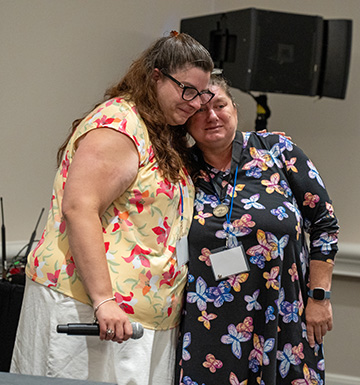 Cassie McKinney and Casey Robertson share a warm hug.