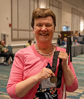A smiling Pat Maurer holds her Twig Award.