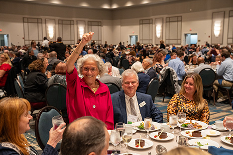 A delighted guest is awarded a door prize at the Convention Banquet.