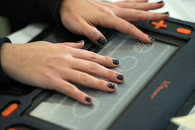 Hands explore the Monarch display.