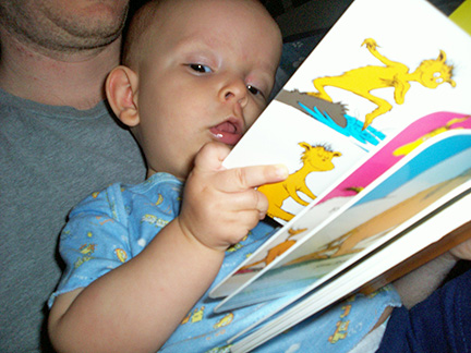 Ivan holds a Dr. Seuss book.