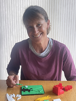 Maureen Handwerker assembles one of her 3-D puzzles.