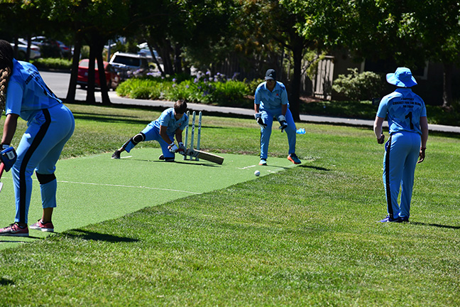 A player of blind cricket prepares to hit the ball.