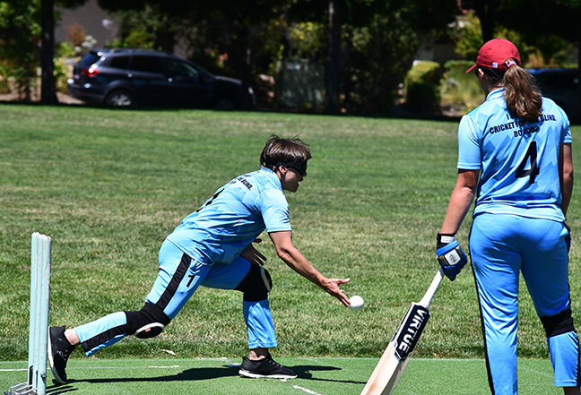 A player pitches the ball in blind cricket.