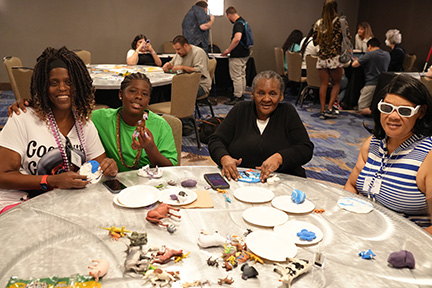 Shawana Gray, Antoine Warren, Virginia Mehu, and Rena McComb work together on a tactile art project.