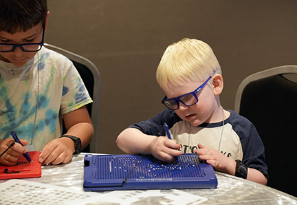 Ryan Bergeron plays with the Braille Doodle.