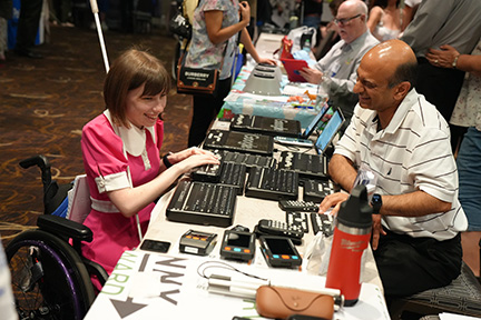 Ellana Crew tests out the Orbit Reader in the Exhibit Hall.