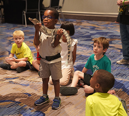 Aiden Jones holds Elvis the Alligator in Kids&rsquo; Camp.