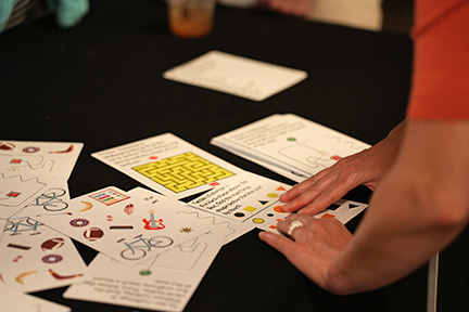 Hands examine a Tactile Challenge Card.