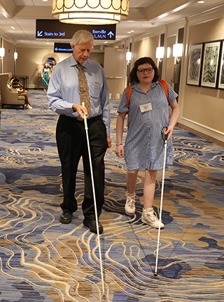 Jeff Altman instructs Rebecca Godwin at the Cane Walk.
