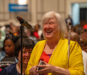 Norma Crosby stands at a mic during a General Session.