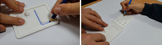 Figure 5. A student’s hand tracing a Hangul letter using a 3D literacy aid.
