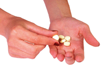 Hands holding some pills.
