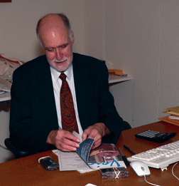 Ed at his desk with the Voice. Photo courtesy of Vicki Palmer