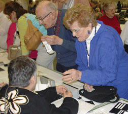 Seniors check out low vision assistance aids at the NFB Seniors Fair.