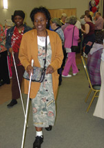 Dorothy DuBois gets a lesson with a long white cane while attending the senior fair.