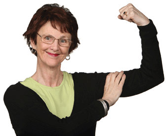 A woman squeezes the muscle on her arm with a triumphant smile on her face.