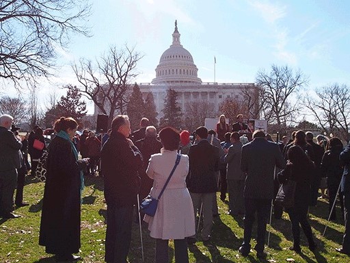 A crowd of NFB members gathers outside near the capitol dome in Washington, DC.