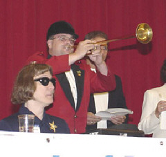 Steve Buttleman, dressed in full regalia, plays the familiar race day bugle call.