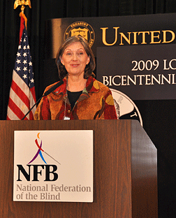 Dr. Joyce Winterton speaks at the podium.