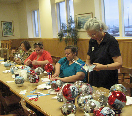 Seated left to right, Alison Hammerbacher, Natalie Shaheen, Treva Olivero, and Lorraine Rovig (standing by the table) decorate ornaments for the White House Christmas tree.