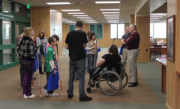 Pictured here are students from the West Virginia School for the Blind as they listen to Dr. Ed Morman explain the process of organizing Jacobus tenBroek&rsquo;s papers, creating the most comprehensive history of our organization and of blind people that has ever been assembled in one place.