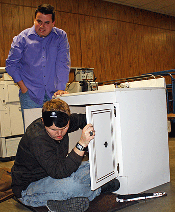 Eric Guillory (LA) instructs Saylor Cooper (TX) in retrieving a ring that has gone down the drain. Saylor is removing the trap under the sink.