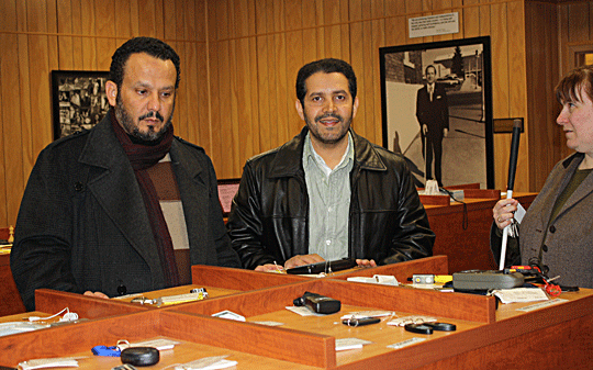 Visitors from the Kingdom of Saudi Arabia, Khaled Suleiman Abdullah and Ahmed M. Alammar, shop in the Independence Market. Ellen Ringlein answers their questions and prepares to demonstrate the aids and appliances we sell.