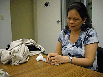 Angela Marin is pictured here making clothing labels.