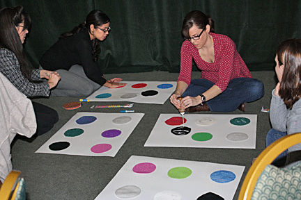 A group of teachers creates a tactile twister board.