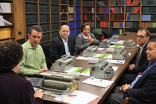 Mrs. Maurer and a group of people sit at a conference table.