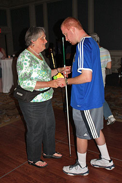 On Wednesday evening the NFB Spanish translation committee sponsored a �Salsa Night in Dallas,� in which instructors taught students how to dance using the familiar six-dot Braille cell. Shown here are Ramona Walhof and her instructor.