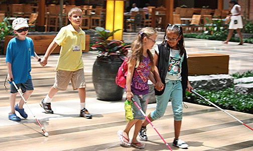 Four youngsters joyfully explore the hotel at the 2012 convention of the National Federation of the blind.