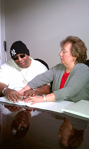 Charlene Smyth teaches Charles Powell Braille.