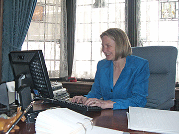 Shawn Mayo at her desk in the library of Pillsbury Mansion.