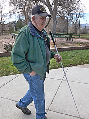 Reuben Hernandez walking confidently with his cane.