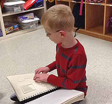 Caleb reading his new book in the classroom
