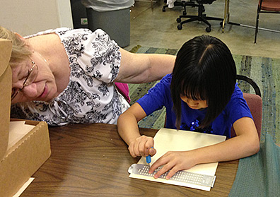 TVI Linda helps Gianna use a slate and stylus