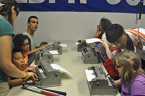 Six participants using Perkins Braillers in a journaling session